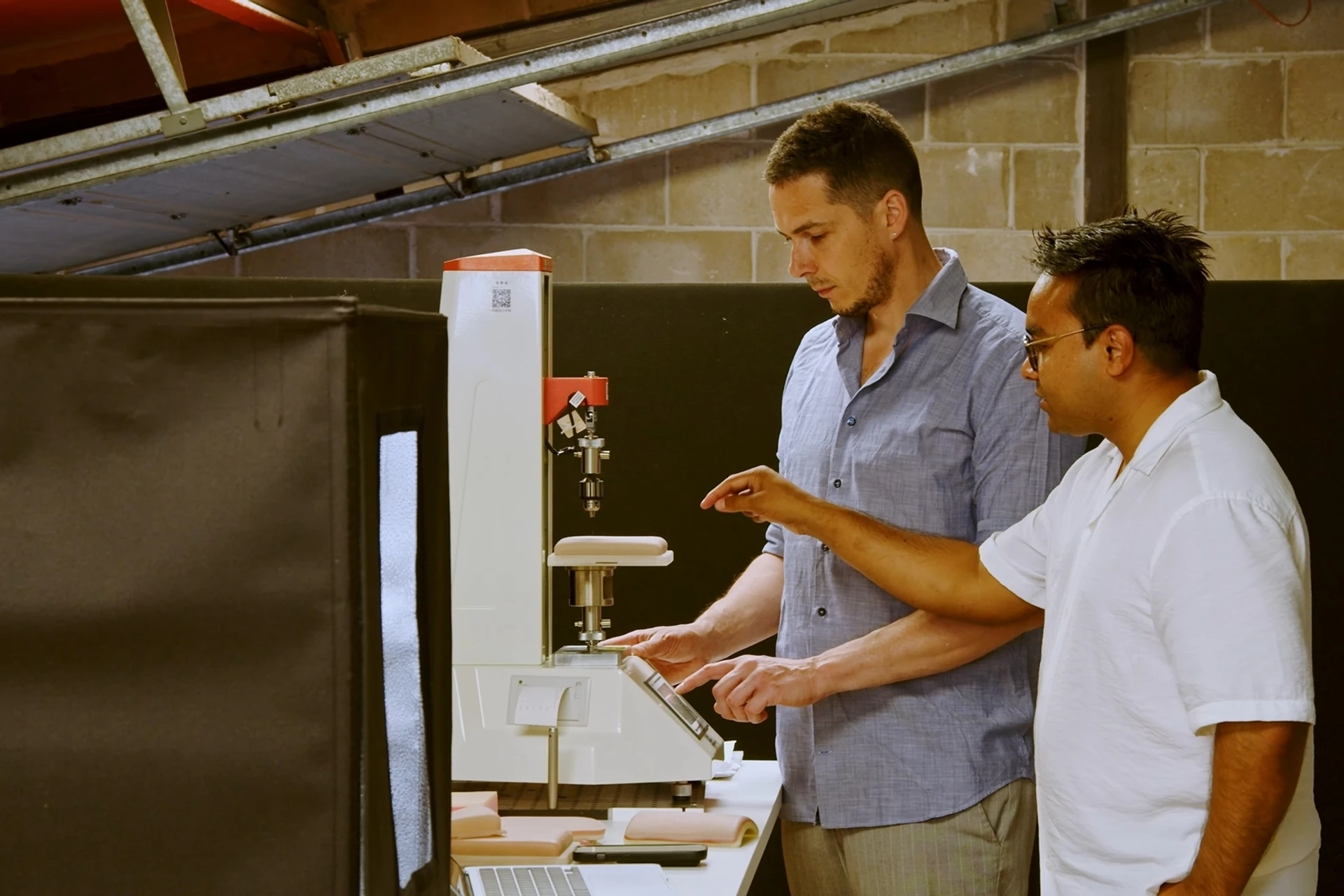 Co-founders running a load-test on a prosthetic together
