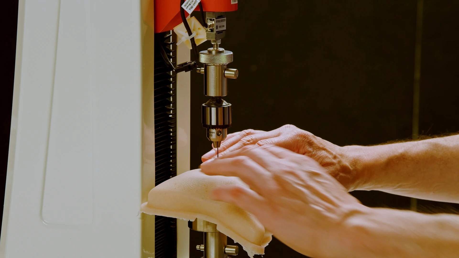 Materials testing rig under load - drill-press point indenting a soft prosthetic