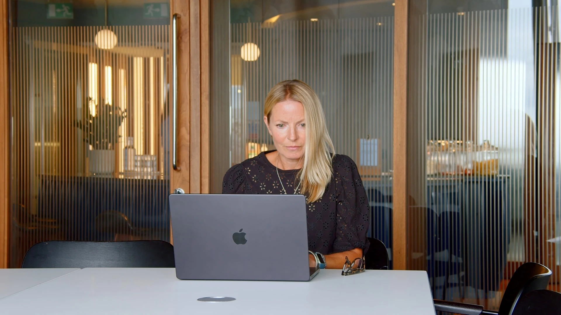 Jude Legg, Compliance Lead at Firefish, reviewing a contract in a meeting room